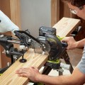 Ryobi PBT01B Cordless Miter Saw Cutting Wood Board